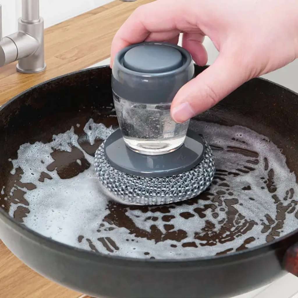 Handheld dish brush with soap dispenser